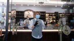 A waitress handles takeaway coffee at a cafe in Rome on Monday.
