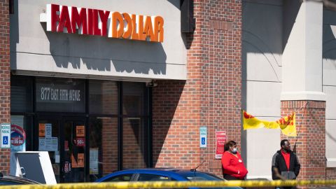 In this Friday, May 1, 2020 photo, employees stand outside the Family Dollar as police investigate a shooting that took place at the store in Flint, Mich. 