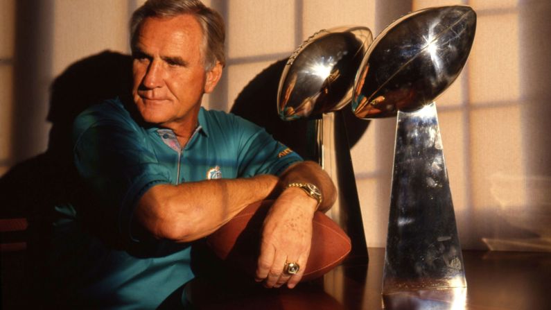 In 1982, Don Shula poses with the two Vince Lombardi trophies that he won with the Miami Dolphins. Shula coached the Dolphins to back-to-back titles in the early 1970s.