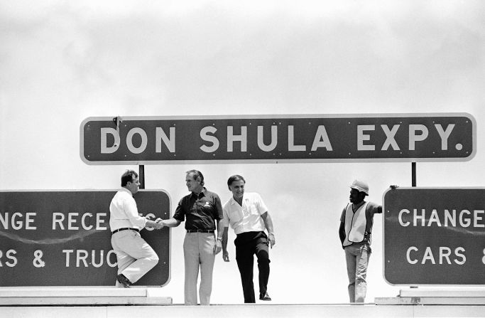 Shula is congratulated atop a toll booth in Miami after a highway was named after him in 1983.