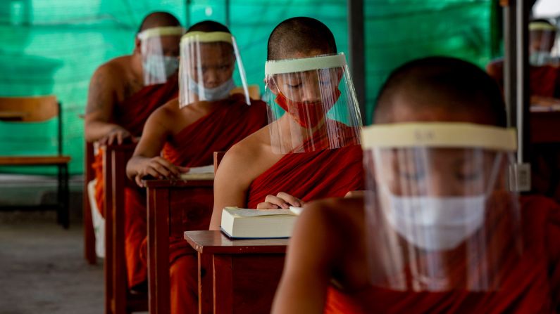 Novice Buddhist monks wear face shields at the Molilokayaram Educational Institute in Bangkok, Thailand, on April 15.