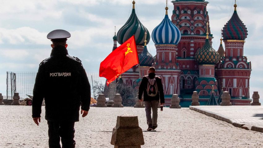 A Russian Communist party supporter carries a red flag as he walks along Red Square in Moscow on May 1, 2020. - The Labour Day celebrations were cancelled due to pandemic threat of Covid-19. (Photo by Yuri KADOBNOV / AFP) (Photo by YURI KADOBNOV/AFP via Getty Images)