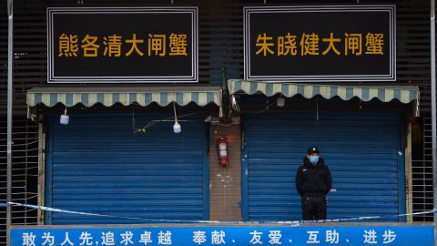 A security guard stands outside the Huanan Seafood Wholesale Market in Wuhan where the coronavirus was detected on January 24, 2020.
