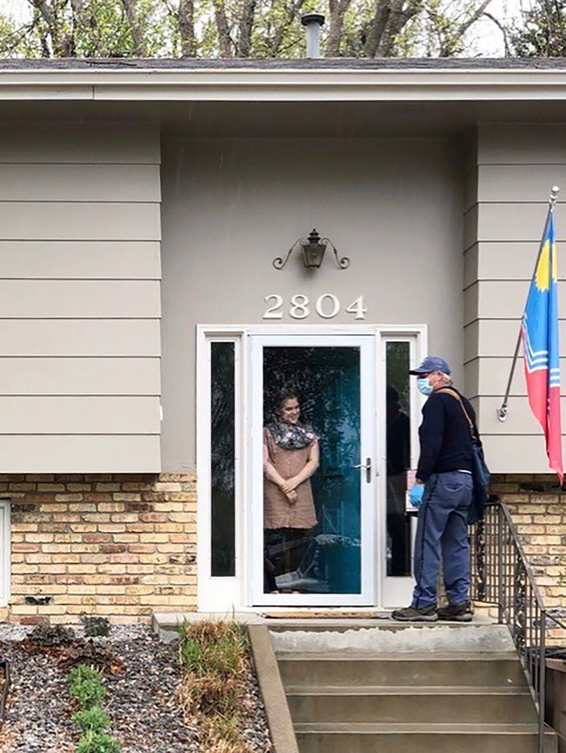 Emerson greets her mail carrier, Doug Scott, at her front door.