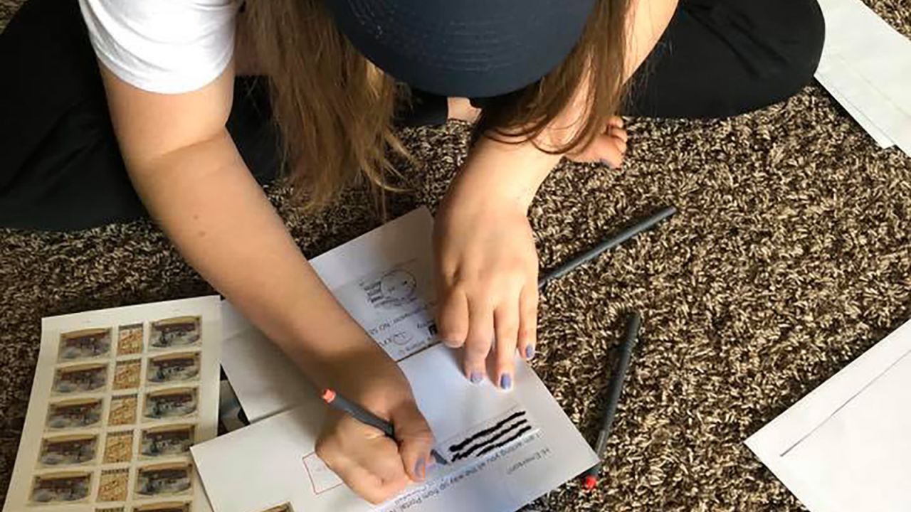 Emerson decorates a fresh batch of letters for her new friends.