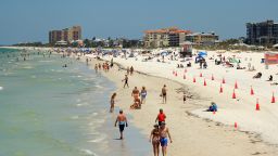People visit Clearwater Beach after Governor Ron DeSantis opened the beaches at 7am on May 04, 2020 in Clearwater, Florida.  Restaurants, retailers, beaches and some state parks reopen today with caveats, as the state continues to ease restrictions put in place to contain COVID-19.  (Photo by Mike Ehrmann/Getty Images)