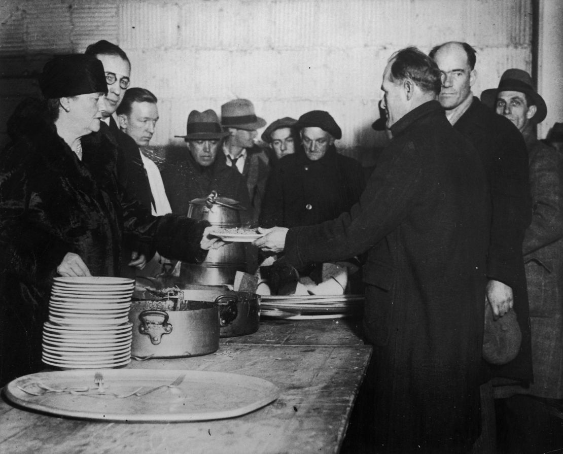 Volunteers help serve meals to the hungry at a Salvation Army soup kitchen in late December 1930.