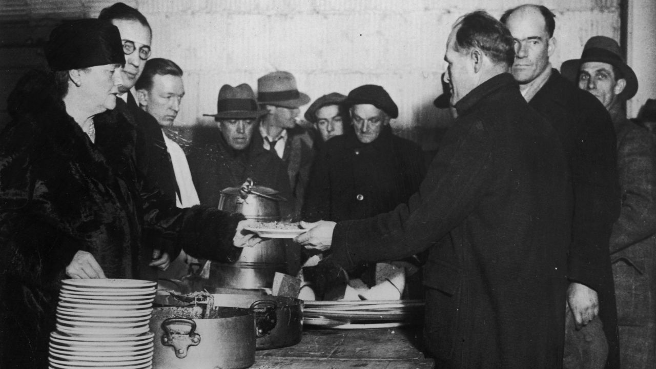 Volunteers help serve meals to the hungry at a Salvation Army soup kitchen in late December 1930.