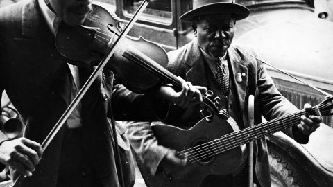 Two street musicians try to earn a living in West Memphis, Arkansas, in 1935. 