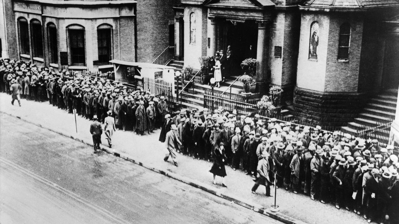Unemployed workers line up for free meals in 1930 at a Franciscan church in New York City.