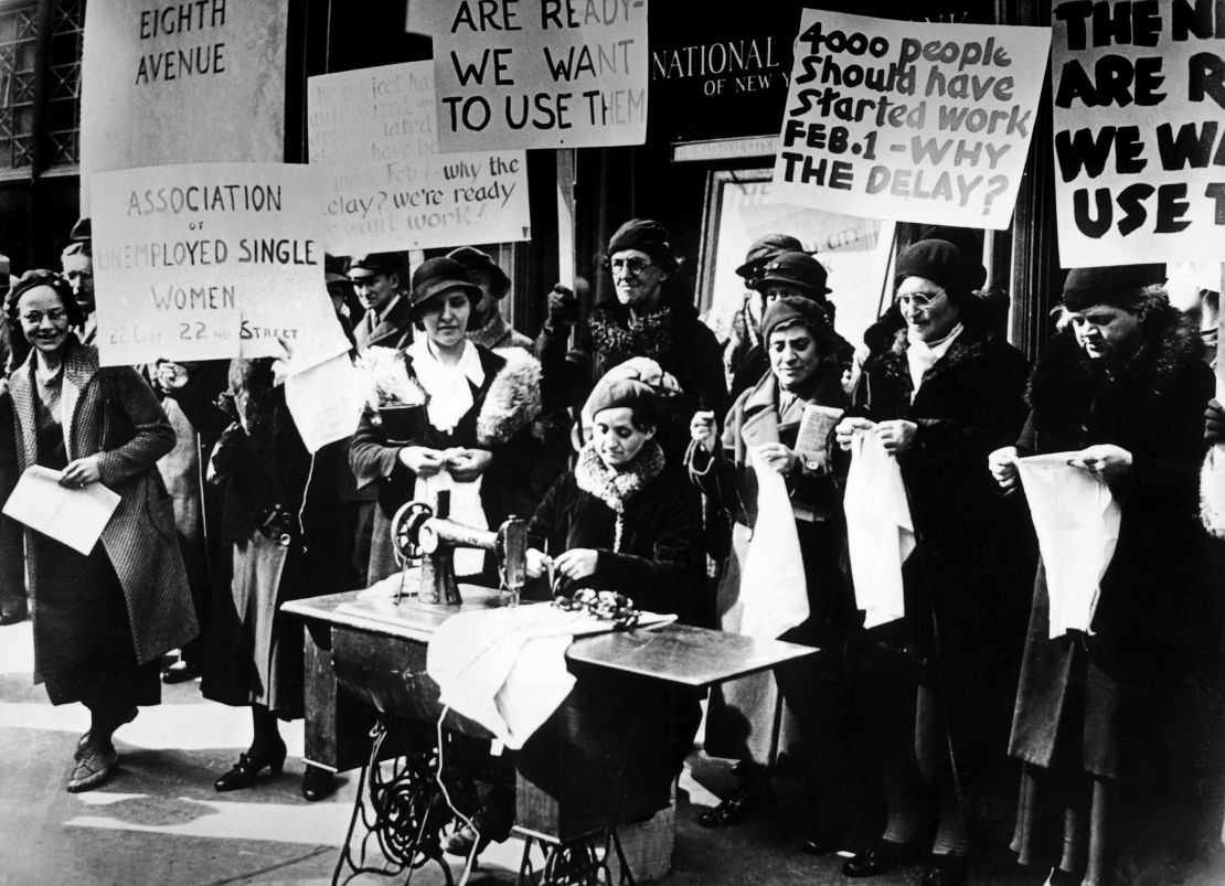 Unemployed workers demonstrate outside government offices to demand jobs during the Depression.
