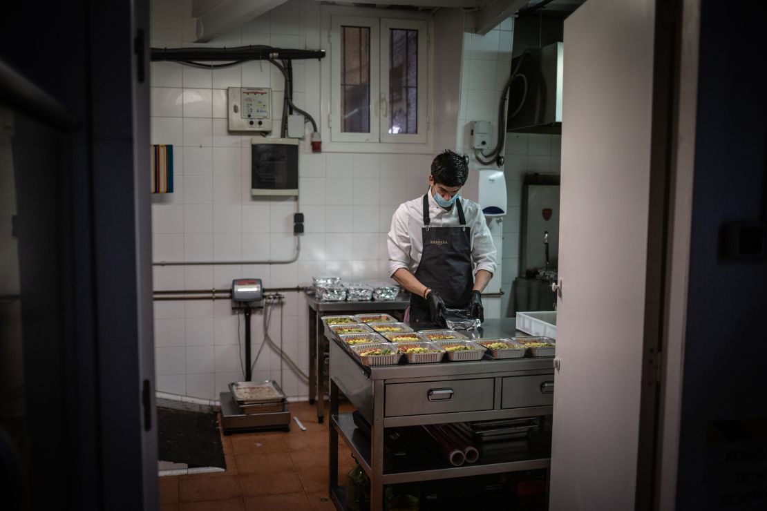 A cook works in Barcelona, Spain on April 16 after his restaurant's kitchen was converted to prepare food for health personnel and vulnerable people.