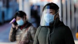 A woman wearing face mask walks on the street at Flushing's Chinatown amid novel coronavirus outbreak on April 6, 2020 in New York City. 
