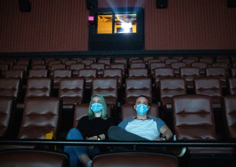 Kayleigh Tansey and Justin Smith watch a movie in Kyle, Texas, on May 4. The EVO Entertainment movie theater reopened after Gov. Greg Abbott lifted a shelter-in-place order and allowed select businesses to open to the public at no more than 25% capacity. 