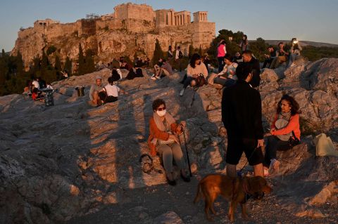 People in Athens, Greece, enjoy a sunset May 5 on the Areopagus hill near the Acropolis.