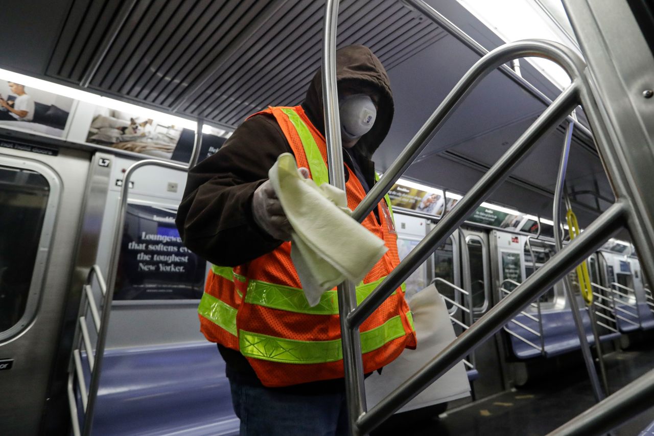 A worker helps disinfect a subway train in New York on May 6, 2020. The subway syatem was shut down for a deep-cleaning.