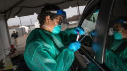 NEW YORK, NY - MARCH 28: A health worker handles a coronavirus swab test at a drive-thru testing center for COVID-19 at Lehman College on March 28, 2020 in the Bronx, New York City. The center, opened March 23 at Lehman College, can test up to 500 people per day for COVID-19. (Photo by John Moore/Getty Images)
