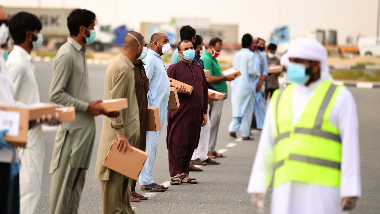 Volunteers distribute Iftar meals to migrant workers keeping distance from each other during the Muslim holy month of Ramadan.
