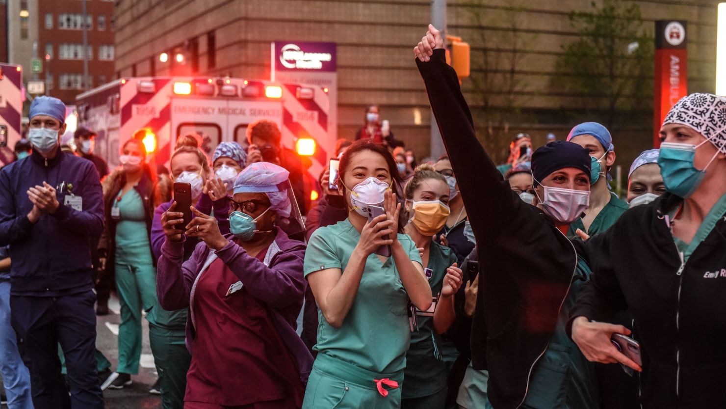 Nurses react as community members applaud them on Thursday, April 30, at NYU Langone Hospital in New York. Every night at 7, medical workers take a break as the community shows their appreciation.