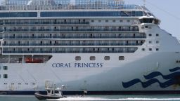 MIAMI, FLORIDA - APRIL 04: A Miami-Dade police boat passes the cruise ship Coral Princess after it docked at Port Miami  on April 04, 2020 in Miami, Florida. Reports indicate that their are passengers and crew members that have tested positive for COVID-19. (Photo by Joe Raedle/Getty Images)