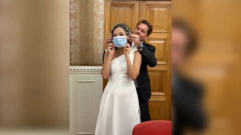 Ivan puts a surgical mask on new bride Rana. Photo: Keith Richburg