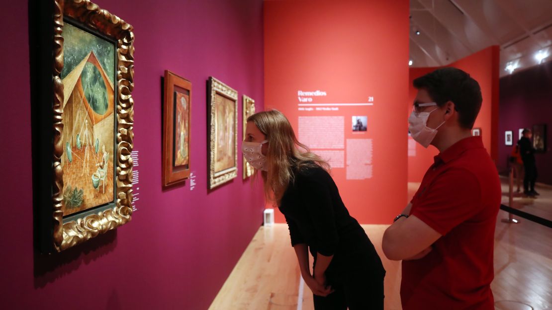 Visitors wearing face masks walk through an exhibition at the Schirn Kunsthalle Frankfurt art museum Wednesday, on the first day the museum reopened to the public during the coronavirus crisis.