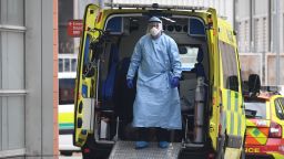 A health worker wear PPE as he stands in an ambulance after transferring a patient into  The Royal London Hospital in east London on April 18, 2020, during the novel coronavirus COVID-19 pandemic. - Britain's death toll from the coronavirus rose by 847 on Friday, health ministry figures showed, a slightly slower increase than the previous day but still among the worst rates globally. (Photo by DANIEL LEAL-OLIVAS / AFP) (Photo by DANIEL LEAL-OLIVAS/AFP via Getty Images)