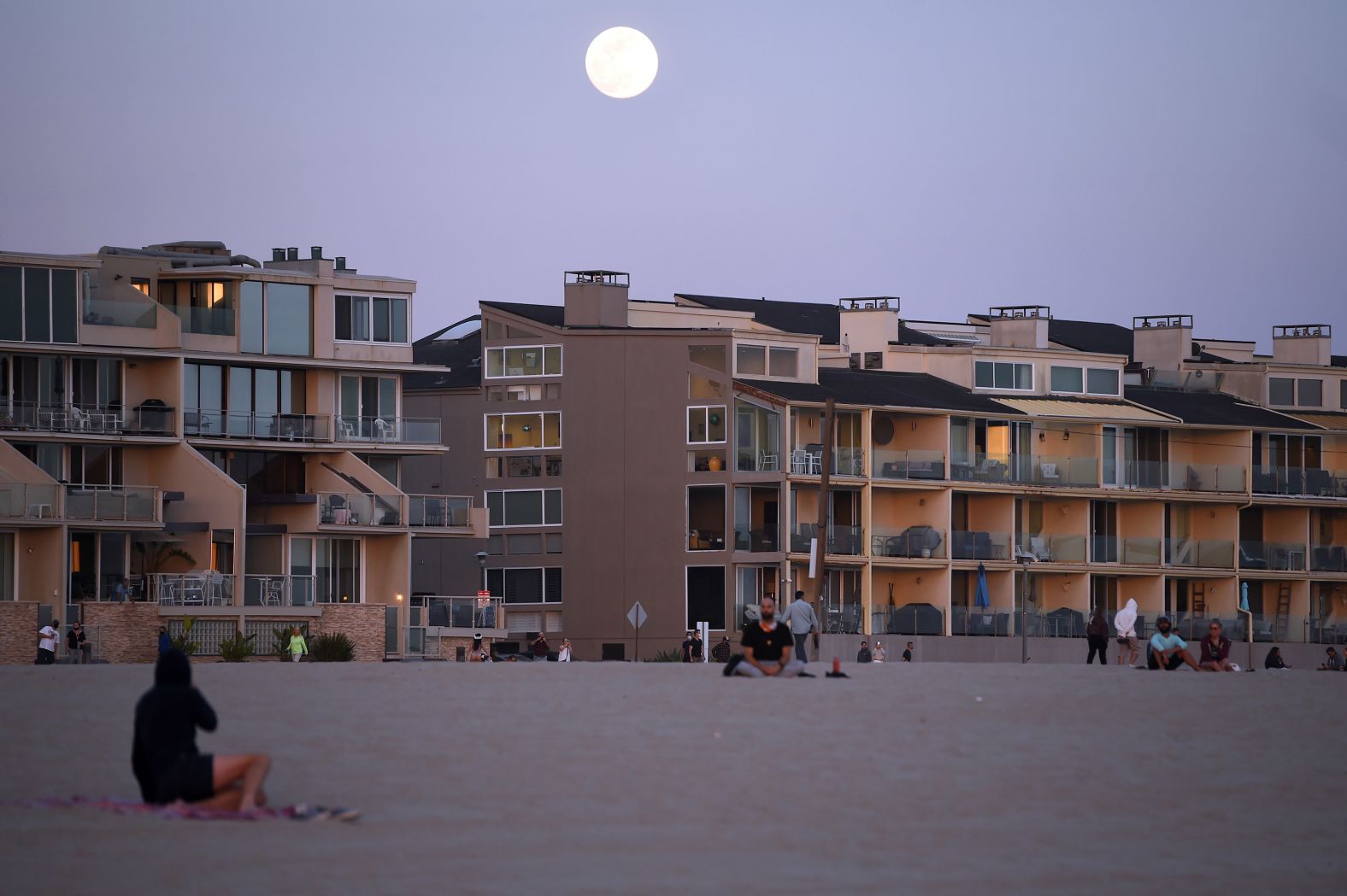 The moon rises above homes in Venice Beach, California.