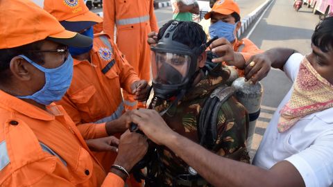 A National Disaster Response Force (NDRF) soldier is fitted with gear before he proceeds to the area from where chemical gas leaked in Vishakhapatnam, India, Thursday, May 7, 2020. 