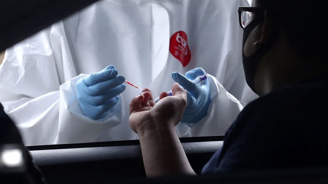 A health worker collects a man's blood sample for a coronavirus antibody test in Tangerang, Indonesia, on May 4.