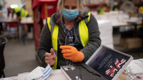 A factory worker in Aylesford, England, prepares commemorative figures for VE Day while wearing personal protective equipment to guard against the coronavirus on Tuesday, May 5.
