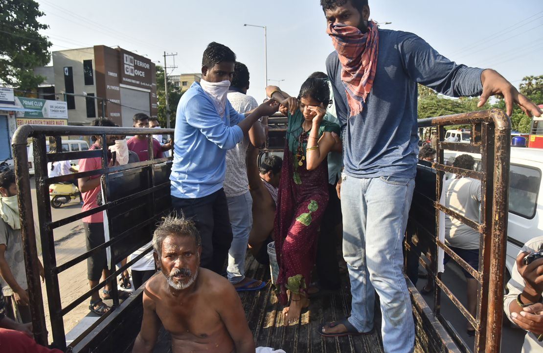 People affected by the gas leak are carried out of a truck to an ambulance in Vishakhapatnam.