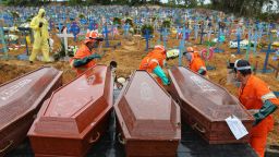 Coffins are unloaded to be buried in a mass grave at the Nossa Senhora cemetery in Manaus, Amazon state, Brazil on May 6, 2020. (Photo by MICHAEL DANTAS/AFP via Getty Images)