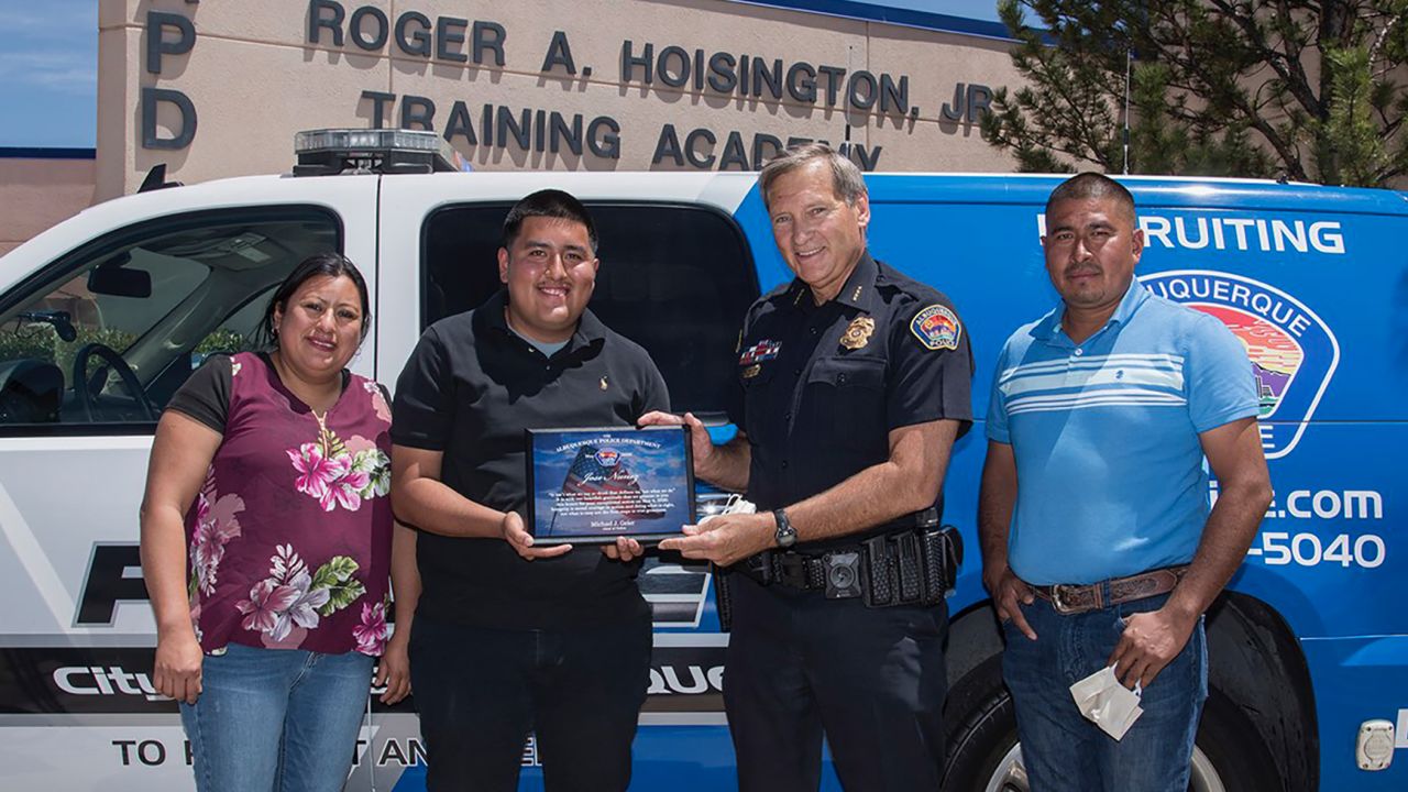 Albuquerque officials celebrated Jose Nunez's decision on Thursday. He holds a plaque presented by Police Chief Mike Geier. They are flanked by Nunez's parents, Carmen Romaniz and Jose Nunez Juarez.