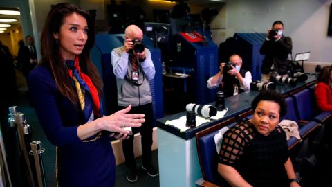 PBS reporter Yamiche Alcindor, seated, watches as One America News White House Correspondent Chanel Rion asks a question of President Donald Trump during a briefing. (AP Photo/Alex Brandon)