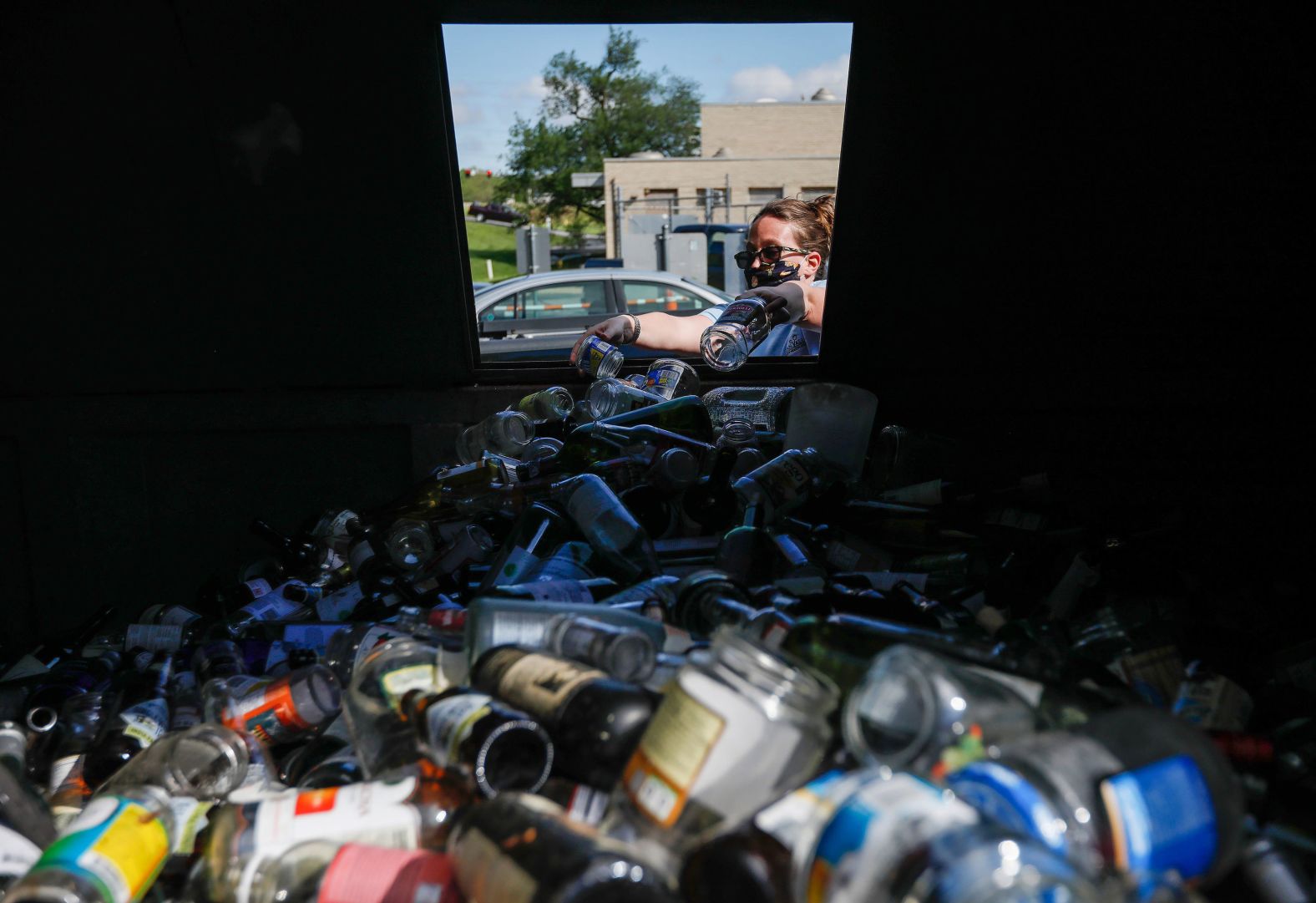 Kelly Watson puts glass in a recycling bin in Springfield, Missouri, on May 6, The Lone Pine Recycling Center had just reopened.