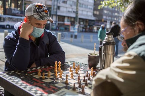 Two men wearing face masks play chess in Montevideo, Uruguay, on May 7.
