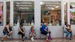 Customers wait for to get their nails done 4at the Nail Tech salon in the Yuba Sutter Mall in Yuba City, Calif., Wednesday, May 6, 2020. Several dozen shoppers streamed into the first California mall to reopen Wednesday, despite California Gov. Gavin Newsom's orders restraining businesses because of the coronavirus pandemic. (AP Photo/Rich Pedroncelli)