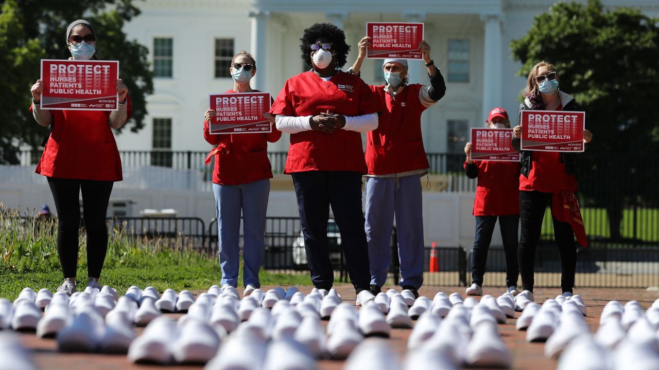 Members of the National Nurses United protest  across from the White House on Thursday. The nurses say the shoes represent other nurses who've died from Covid-19. 