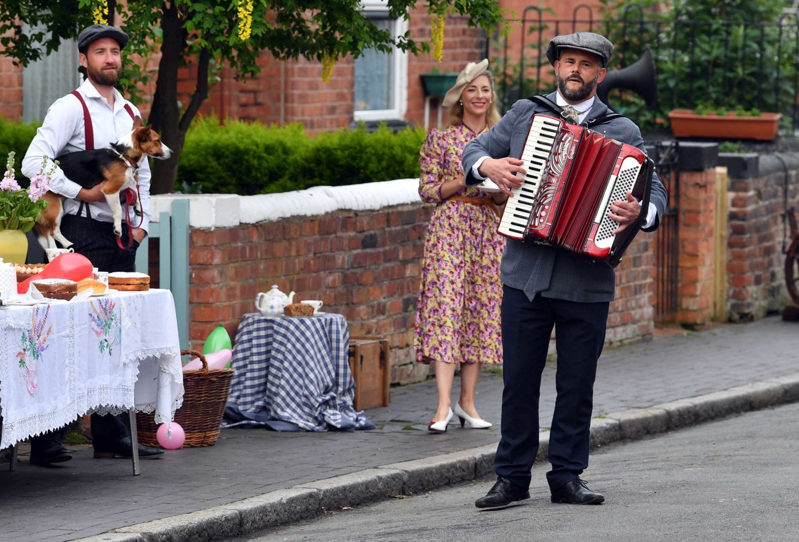 People in Chester, England, are dressed in costume as they take part in a street party to mark VE Day.