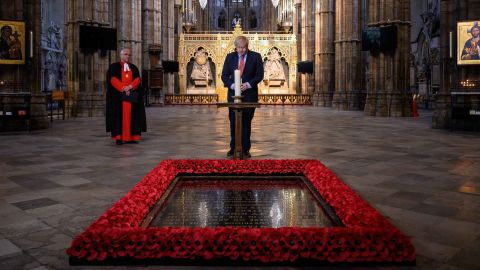 British Prime Minister Boris Johnson lights a candle at the grave of the Unknown Warrior in London's Westminster Abbey.