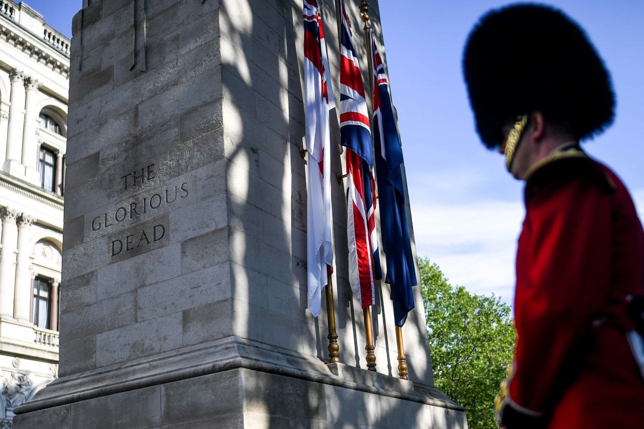 A member of the British Armed Forces stands next to The Cenotaph war memorial in London.