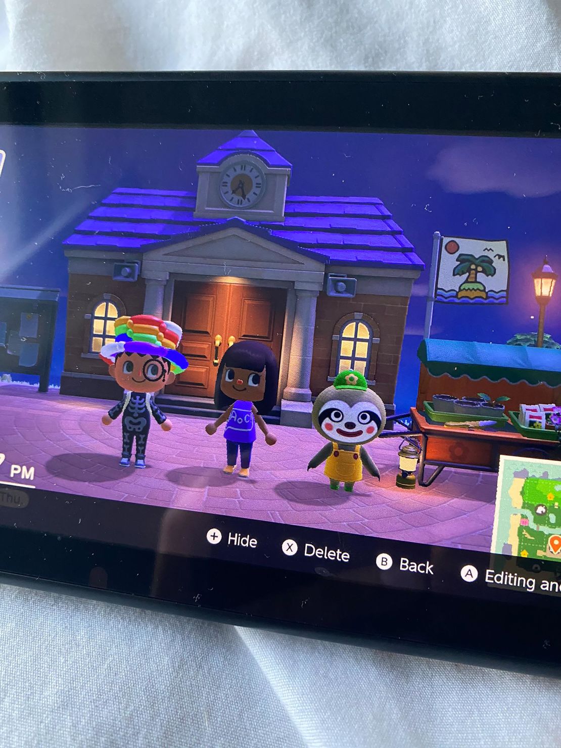 Alexandria Ocasio-Cortez tweeted this photo showing her "Animal Crossing" game. The figure in the center, Ocasio-Cortez's apparent avatar, is sporting a custom "AOC" T-shirt, while the figure on the right is a sloth who sells plants. 