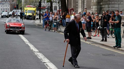 People applaud as a World War II veteran walks past them in London.