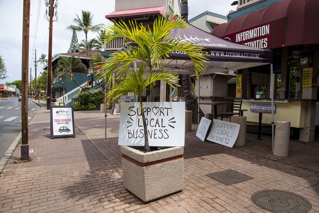 "Support Local Business" signs are posted along Front Street in Lahaina, Hawaii, on Friday.