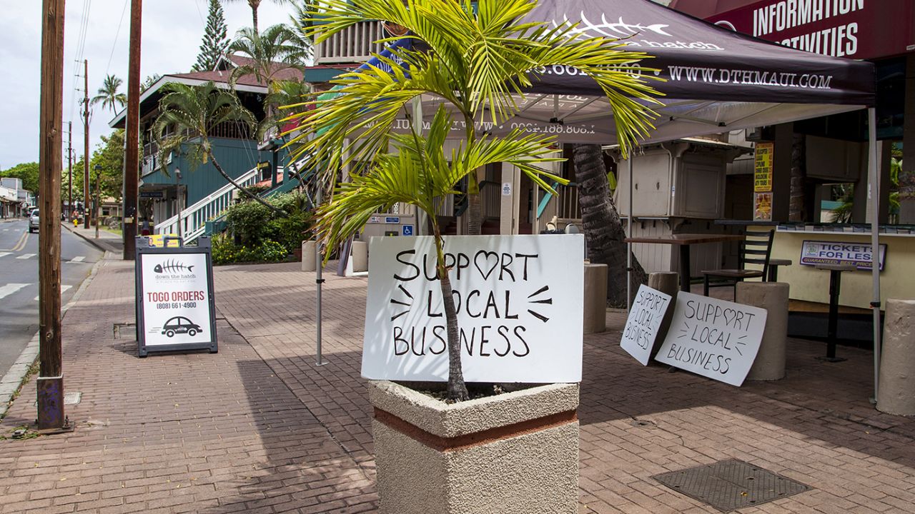 "Support Local Business" signs are posted along Front Street in Lahaina, Hawaii, on Friday.