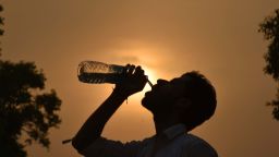 NEW DELHI, INDIA - APRIL 3: A man drinks water from the water bottle during a hot weather, as the heat wave conditions prevailed in Northern India with the maximum temperature settling at 38.9 degrees Celsius, five notches above the normal, on April 3, 2016 in New Delhi, India. The minimum temperature yesterday was recorded at 21.6 degrees Celsius while the maximum had settled at 37.3 degrees Celsius. (Photo by Raj K Raj/Hindustan Times via Getty Images)
