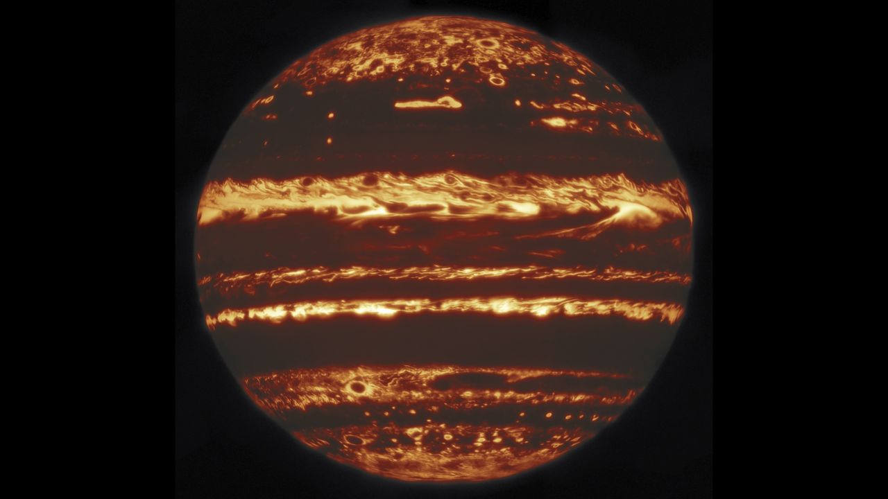 This jack-o-lantern-esque view of Jupiter is a mosaic of images taken by the Gemini North telescope in Hawaii. The bright spots represent Jupiter's internal heat escaping through holes in the planet's massive cloud cover. 