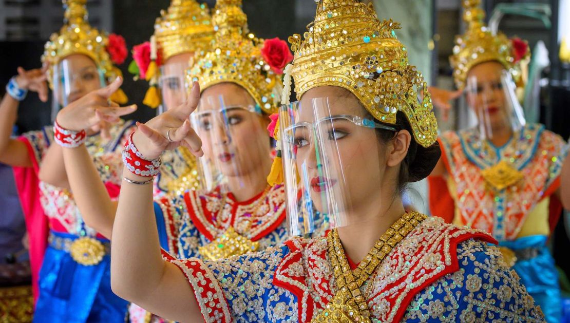 Traditional Thai dancers wearing protective face shields perform at Bangkok's Erawan Shrine, which was reopened after the Thai government relaxed measures to combat the spread of Covid-19 on May 4.