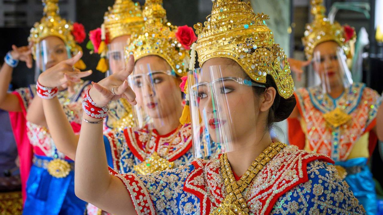 Traditional Thai dancers wearing protective face shields perform at Bangkok's Erawan Shrine, which was reopened after the Thai government relaxed measures to combat the spread of Covid-19 on May 4.